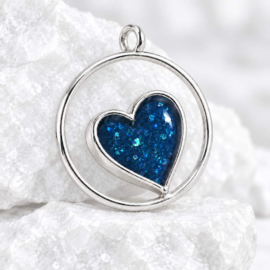 Circle of Love silver pendant with blue resin heart on bright white textured stone
