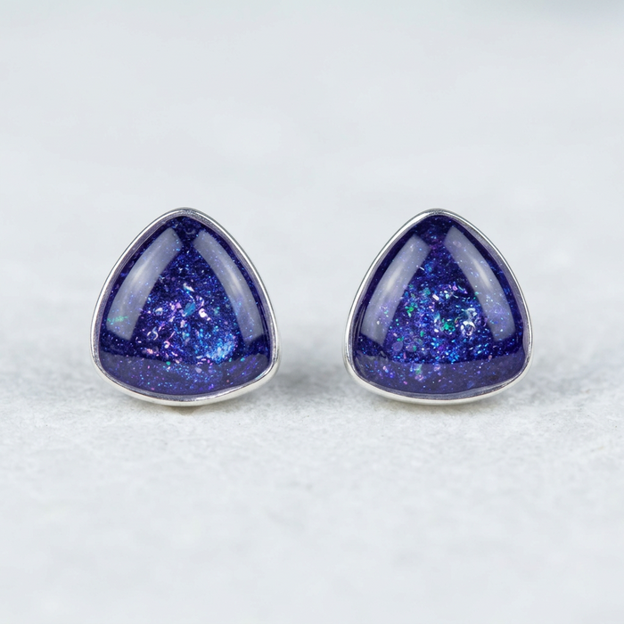 Triangle stud earrings on white stone
